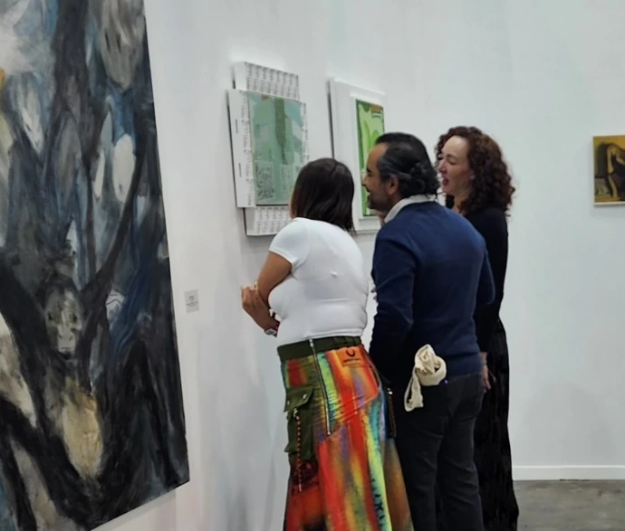 art galerist advising and explaining a painting